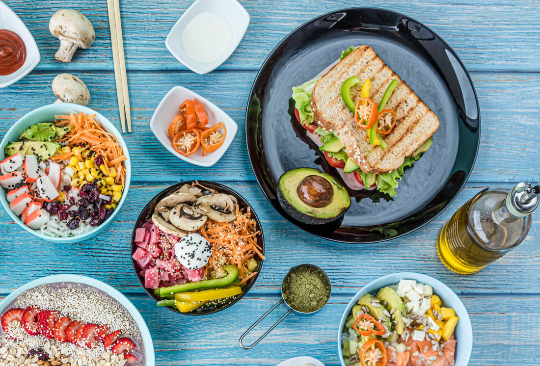 Healthy Food Flat Lay with Poke Bowls, Oatmeal, and Sanwich